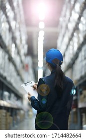 Warehouse Worker Taking Inventory In Logistics Warehouse