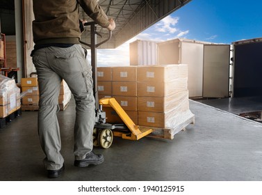 Warehouse Worker Unloading Package Boxes into Cargo Container Truck.Trailer Truck Parked Loading at Dock Warehouse. Supply Chain Delivery Service. Shipping Warehouse Logistics. Freight Truck Transport