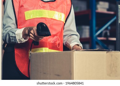 Warehouse worker using barcode scanner in storehouse . Logistics , supply chain and warehouse business concept .