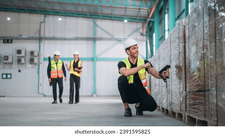 Warehouse worker using barcode scanner in warehouse. Engineer is working and checking the stock at the manufacturing.