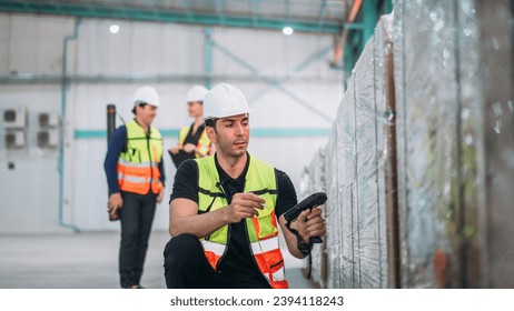 Warehouse worker using barcode scanner in warehouse. Engineer is working and checking the stock at the manufacturing.