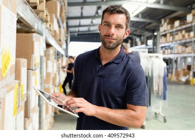 Warehouse worker using digital tablet in distribution warehouse