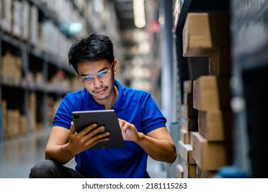 Warehouse Worker using digital tablets to check the stock inventory in large warehouses, a Smart warehouse management system, supply chain and logistic network technology concept.