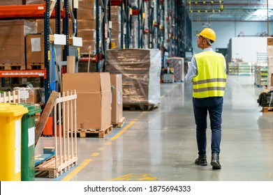 Warehouse worker using laptop and entering data to database
