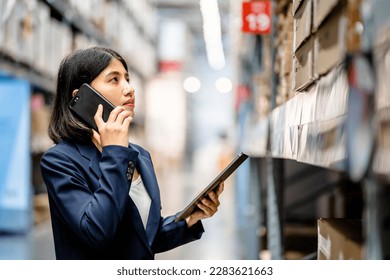 Warehouse Worker using smartphone and digital tablets to check the stock inventory in large warehouses, a Smart warehouse management system, supply chain and logistic network technology concept - Powered by Shutterstock - Get 15% off with code: PIKWIZARD15