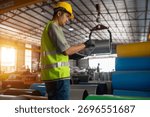 Warehouse worker using tablet to manage inventory industrial facility digital workflow organized environment focused perspective