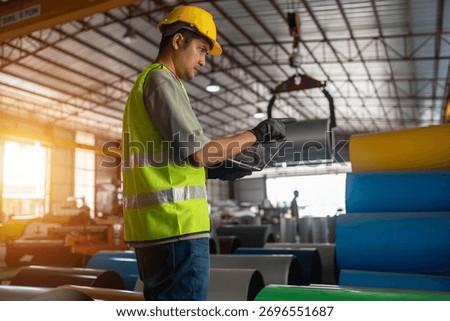 Warehouse worker using tablet to manage inventory industrial facility digital workflow organized environment focused perspective