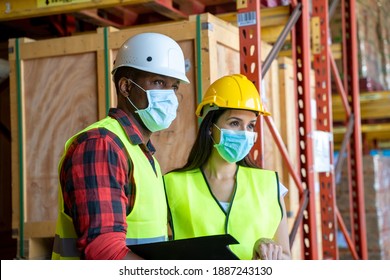 Warehouse Worker Wearing Protective Mask To Protect Against Covid-19 Working In A Large Distribution Warehouse,Logistic Industry Concept.