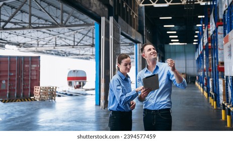 Warehouse worker working and checking the stock in the warehouse. Factory manager using digital tablet check barcode in industry factory logistic.