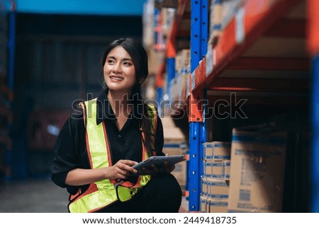 Warehouse worker working and checking the stock in the warehouse. .Factory manager using digital tablet check barcode in industry factory logistic.