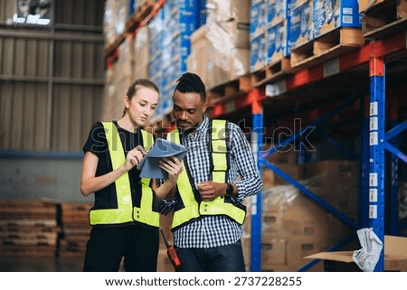 Warehouse worker working and checking the stock in the warehouse. Factory manager using digital tablet check barcode in industry factory logistic.
