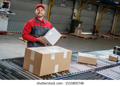 Warehouse Worker Working On A Conveyor Line