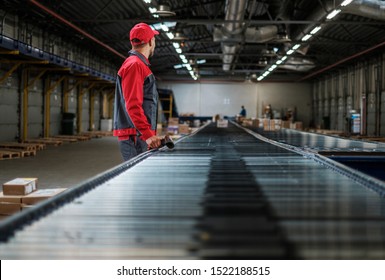 Warehouse Worker Working On A Conveyor Line