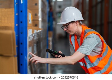 Warehouse worker working process checking the package using barcode reader in a large distribution center. Caucasian female inspects cargo inventory.
