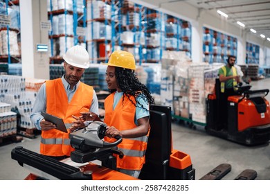 Warehouse workers are checking inventory on a digital tablet and driving a forklift in a large distribution center, ensuring efficient operations and on time deliveries