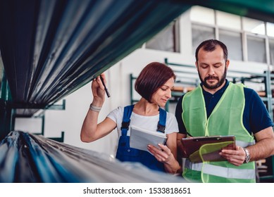 Warehouse Workers Checking Order List For Collecting Products In The Warehouse Of Industrial Factory