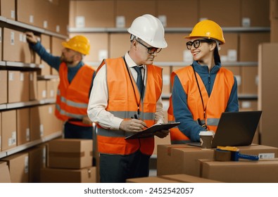 Warehouse workers checking orders on the laptop, logistics and shipping concept