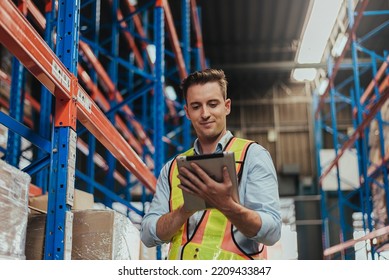Warehouse Workers checking stock with digital Tablet in Logistic center. Caucasian manager wearing safety vests to working about shipment in storehouse, Working in Storage Distribution Center. - Shutterstock ID 2209433847