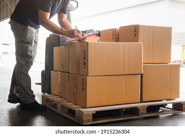 Warehouse Workers Holding Clipboard his Doing Inventory Management Packaging Boxes. Shipping Cargo Goods Boxes Checking Stock. Shipment Boxes. Warehousing Storage.	
