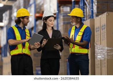 Warehouse workers multi-ethnic discussing work checking inventory and consulting distribution of product at warehouse storage department. Supervisor recommend the inspection and placement of goods