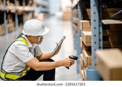 Warehouse workers use scanner checking and scan the barcode of stock inventory to keep storage in a system, Smart warehouse management system, Supply chain and logistic network technology concept.