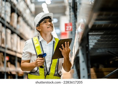 Warehouse workers use scanner checking and scan the barcode of stock inventory to keep storage in a system, Smart warehouse management system, Supply chain and logistic network technology concept. - Powered by Shutterstock