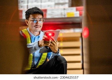 Warehouse workers use scanner checking and scan the barcode of stock inventory to keep storage in a system, Smart warehouse management system, Supply chain and logistic network technology concept.