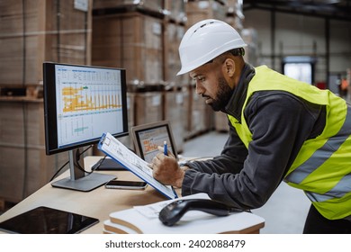 Warehouseman checking delivery, stock in warehouse on computer, pc. Warehouse manager using warehouse management software, app. - Powered by Shutterstock