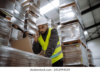 Warehouseman checking delivery, stock in warehouse on computer, pc. Warehouse manager using warehouse management software, app. - Powered by Shutterstock