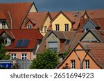 Waren, Germany - May 29, 2025: colorful painted gables of contemporary traditional houses in sunlight in Waren an der Müritz