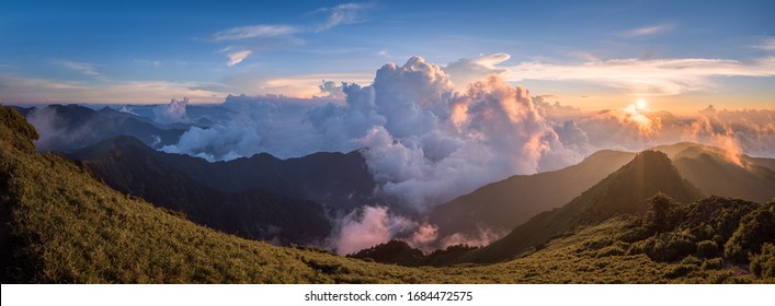Warm afternoon sun setting down over the clouds in warm colors from the top of HeHuanShan in Taiwan - Shutterstock ID 1684472575