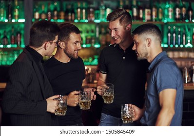 Warm Atmosphere. Friends Resting In The Pub With Beer In Hands. Having Conversation.