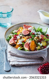 Warm Autumn Quinoa Salad With Baked Vegetables (sweet Potato, Brussels Sprouts), Figs, Feta Cheese And Pomegranate.