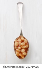 Warm Baked Beans On A Metal Spoon
