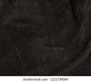 Warm Black Fur Fabric Background