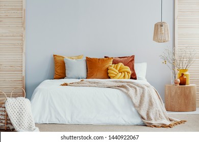 Warm Blanket On White Duvet In Cozy Bedroom Interior