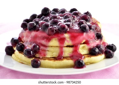 Warm Blueberry Ricotta Pancakes On White Plate