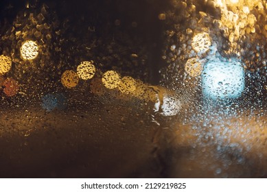 Warm Bokeh Lights In Shape Of Mound On Backdrop Of Evening Street Light In The City. Colorful Overlay Glitter Lights For Layout Design. Bokeh Glows Concept Of Celebration.