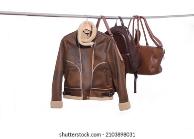 Warm brown leather jacket and two handbag in the hanging