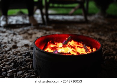 A warm campfire in an outdoor setting, with glowing embers and a cozy atmosphere, evoking feelings of relaxation and leisure. Ideal for themes of nature, camping, or outdoor activities. - Powered by Shutterstock