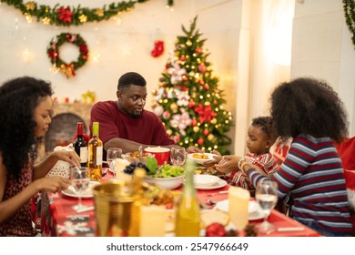 A warm Christmas family dinner with a father serving food to his young child, surrounded by festive decorations, a Christmas tree, and a holiday table spread. Joyful and cozy holiday atmosphere. - Powered by Shutterstock