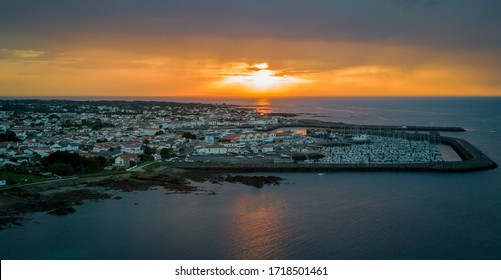 Warm and cloudy sunset faces the harbor of the wonderful Yeu island in France, West Coast