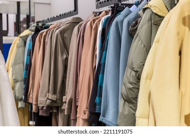 Warm Coats In Different Colors And Textures On Hangers In The Store. New Autumn Winter Collection. Fashion And Style.