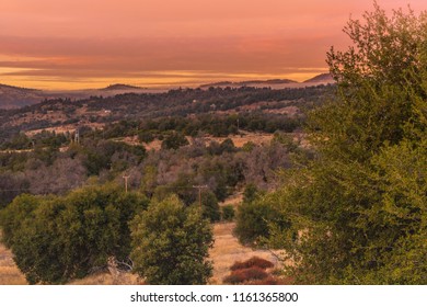 Warm Color Sunset Sky, Orange, Red, Lavender Tones, In Southern California Hills In Autumn, Oaks In Foreground Mountains In Background