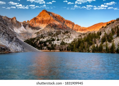 Warm Colors Paint The Top Of Mount Idaho At A Mountain Lake 