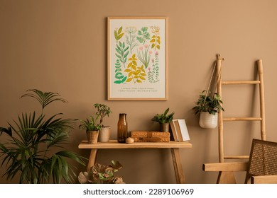 Warm composition of living room interior with mock up poster frame, plants in flowerpots, rattan armchair, wooden bench, books, braided box, brown wall and personal accessories. Home decor. Template.