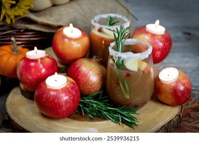 Warm cozy apple cider drink cocktail with a sprig of rosemary and pomegranate and sugar around the rim - Powered by Shutterstock