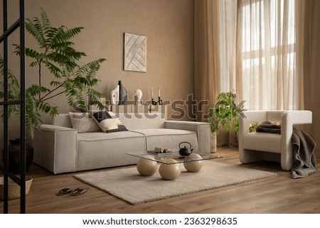 Warm and cozy composition of living room interior with mock up poster frame modular sofa, white armchair, stylish coffee table, plants, beige curtain and personal accessories. Home decor. Template. 
