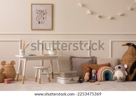 Warm and cozy kids room interior with mock up poster frame, beige wall with stucco, white desk, stool, pillows, plush animal toys, garland on the wall and personal accessories. Home decor. Template.
