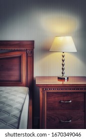 Warm Cozy Lamp Near Bed On Night Stand